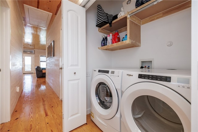 washroom with separate washer and dryer and light hardwood / wood-style floors