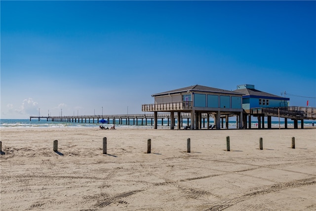 surrounding community featuring a view of the beach and a water view