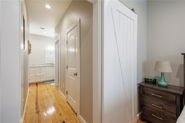 corridor with light wood-type flooring