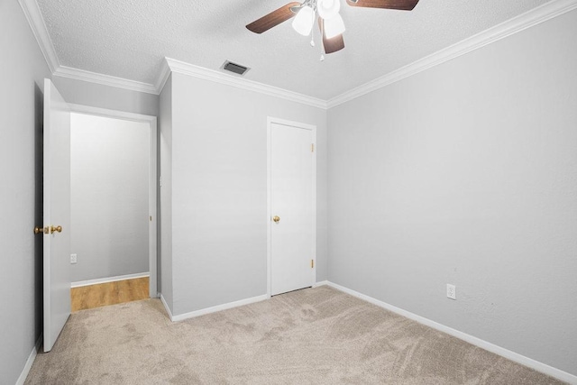 10710 Atlanta St, Corpus Christi, TX 78410 - unfurnished bedroom featuring carpet, a textured ceiling, ceiling fan, baseboards, and ornamental molding