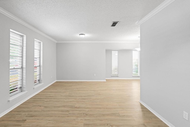 10710 Atlanta St, Corpus Christi, TX 78410 - empty room featuring plenty of natural light, ornamental molding, a textured ceiling, light wood-type flooring, and baseboards