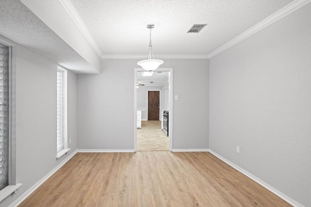 10710 Atlanta St, Corpus Christi, TX 78410 - unfurnished dining area with light wood-style flooring, a textured ceiling, ornamental molding, and baseboards