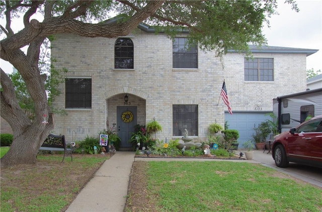 5113 Queens Ct, Corpus Christi, TX 78413 - view of front facade with a front lawn, driveway, brick siding, and an attached garage