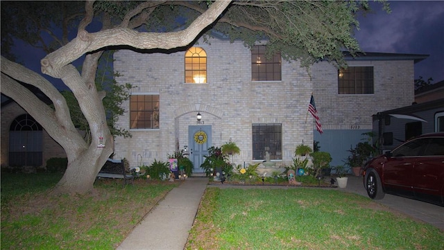 5113 Queens Ct, Corpus Christi, TX 78413 - french country inspired facade with an attached garage, a front lawn, and brick siding