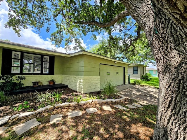 515 Deforrest St, Corpus Christi, TX 78404 - view of front of property featuring an attached garage, concrete driveway, and concrete block siding