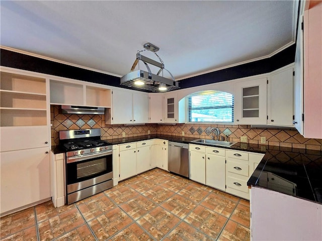 515 Deforrest St, Corpus Christi, TX 78404 - kitchen with stainless steel appliances, under cabinet range hood, dark countertops, open shelves, and decorative backsplash