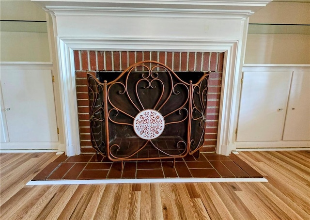 515 Deforrest St, Corpus Christi, TX 78404 - detailed view of wood finished floors, a decorative wall, a fireplace, and wainscoting