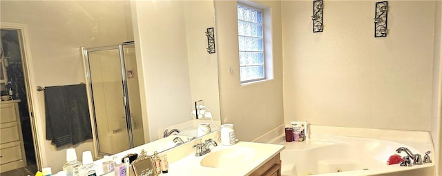 bathroom with vanity and independent shower and bath