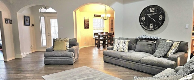 living room with wood-type flooring and a notable chandelier