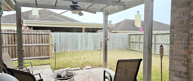 view of yard featuring a fire pit, a patio area, and ceiling fan