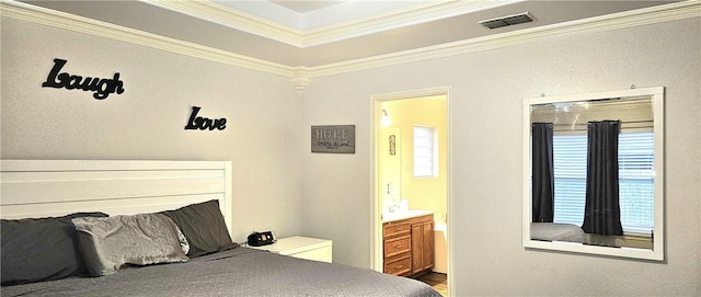 bedroom with crown molding, ensuite bathroom, and wood-type flooring