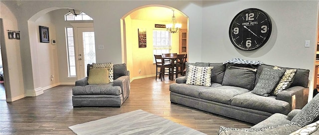 living room featuring a notable chandelier and hardwood / wood-style flooring