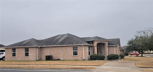 view of property exterior with central AC and a yard