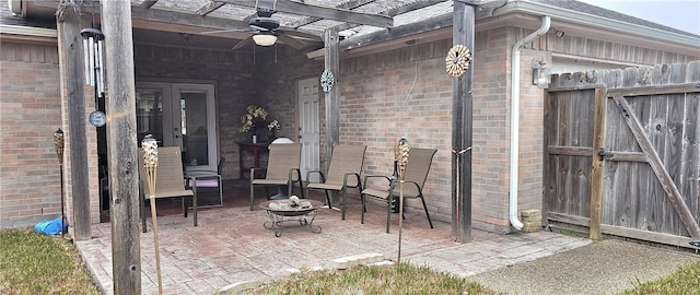 view of patio with ceiling fan and a fire pit