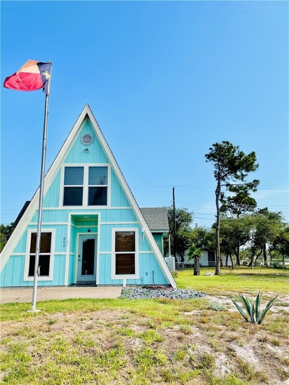 343 Bracht, Rockport, TX 78382 - a-frame style home featuring board and batten siding and a front yard