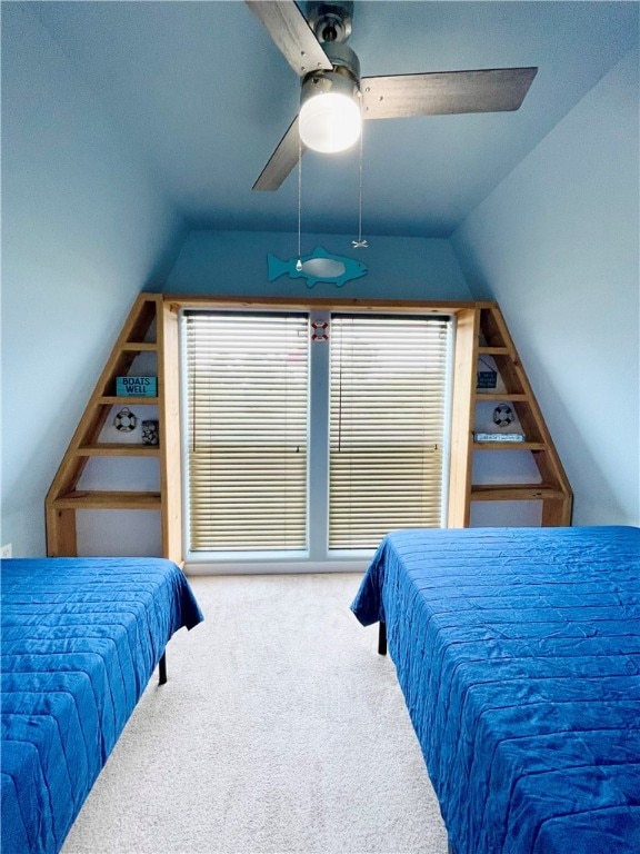 carpeted bedroom with ceiling fan and vaulted ceiling