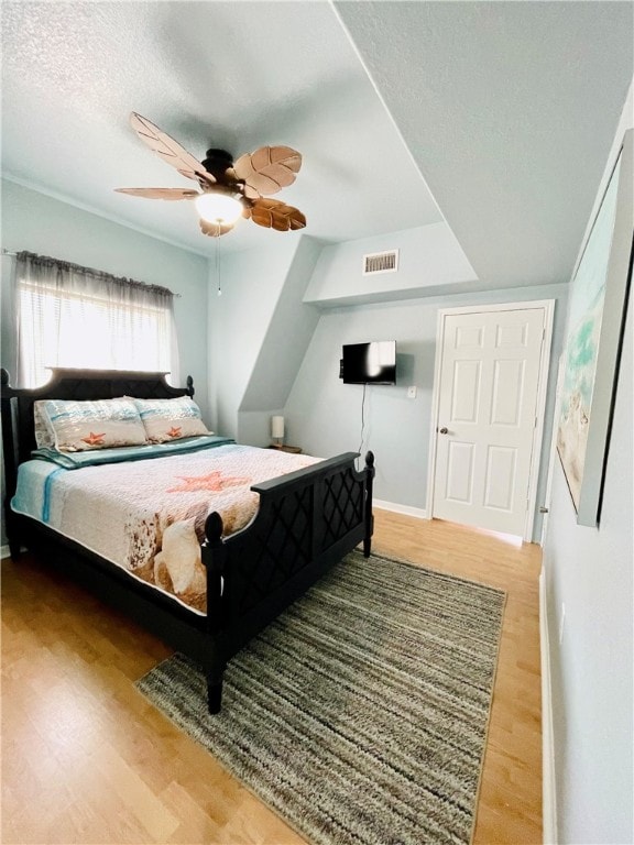 343 Bracht, Rockport, TX 78382 - bedroom with wood finished floors, baseboards, a textured ceiling, and a ceiling fan