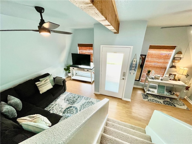 living room featuring light wood-type flooring and ceiling fan