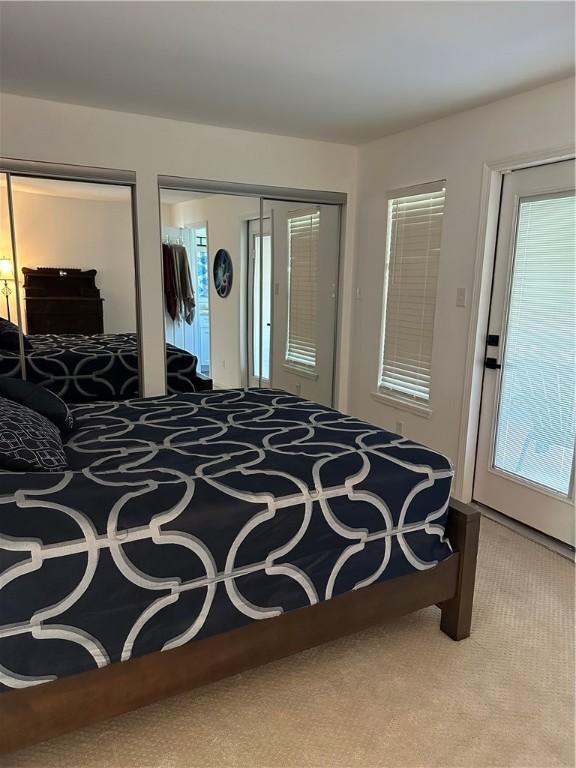 carpeted bedroom with multiple closets