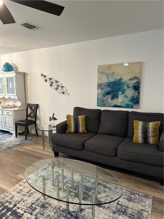 living room featuring visible vents and wood finished floors