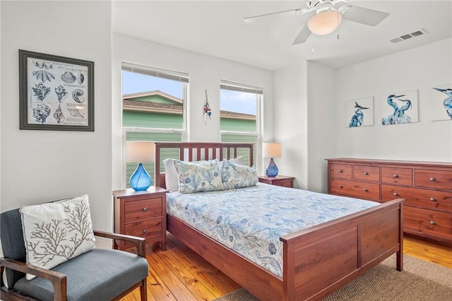 bedroom with ceiling fan and light hardwood / wood-style flooring