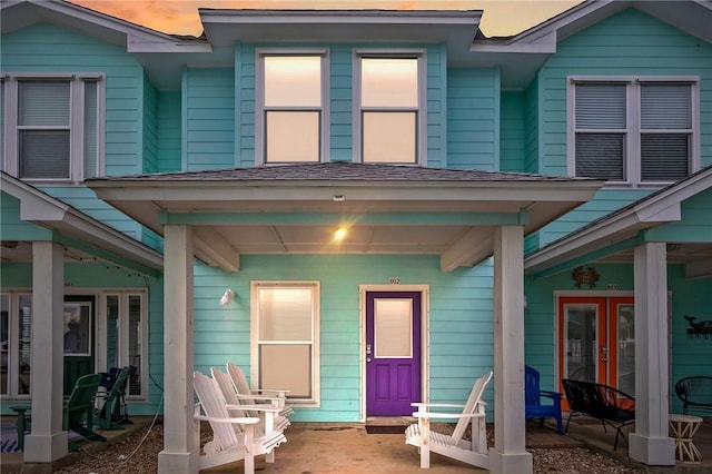 exterior entry at dusk with a porch