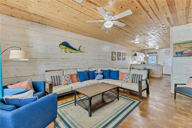 living room featuring concrete flooring, ceiling fan, and wood ceiling