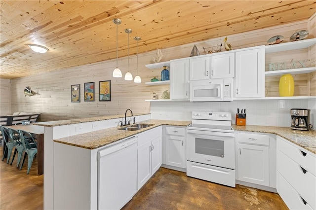 kitchen with sink, white appliances, hanging light fixtures, white cabinets, and kitchen peninsula