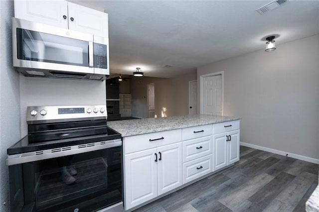 kitchen featuring white cabinetry, ceiling fan, stainless steel appliances, light stone counters, and dark hardwood / wood-style flooring