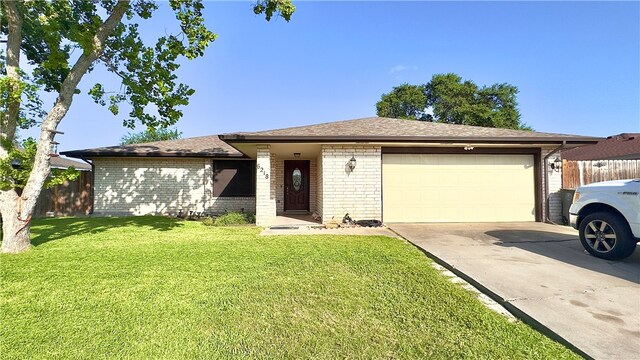 single story home featuring a garage and a front yard