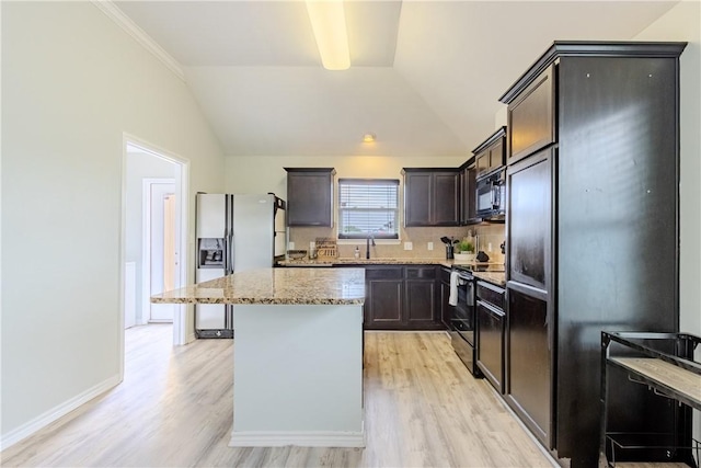 kitchen featuring electric range, black microwave, white fridge with ice dispenser, light wood-type flooring, and lofted ceiling