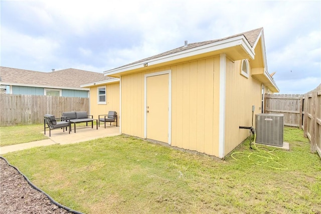 rear view of property with central AC, outdoor lounge area, and a patio
