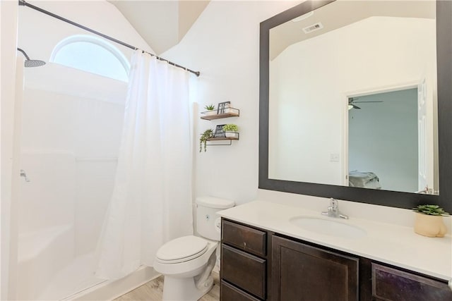 bathroom with curtained shower, vanity, toilet, and lofted ceiling