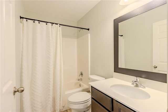 bathroom featuring toilet, vanity, and shower / bath combination with curtain