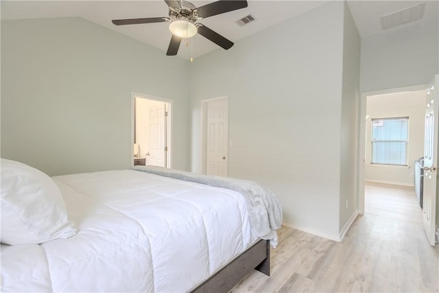 bedroom featuring vaulted ceiling, light wood-style floors, a ceiling fan, and baseboards