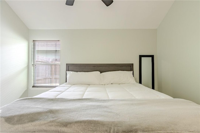 bedroom featuring vaulted ceiling and a ceiling fan
