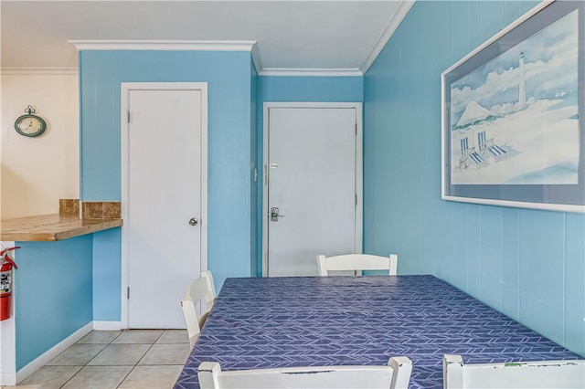 dining room featuring tile patterned flooring and ornamental molding