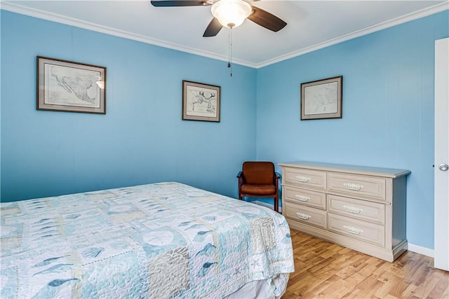 bedroom with light wood finished floors, a ceiling fan, and crown molding