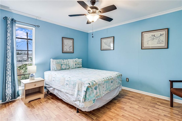 bedroom featuring baseboards, ornamental molding, ceiling fan, and wood finished floors