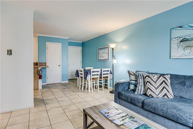 living room featuring crown molding, baseboards, and tile patterned floors