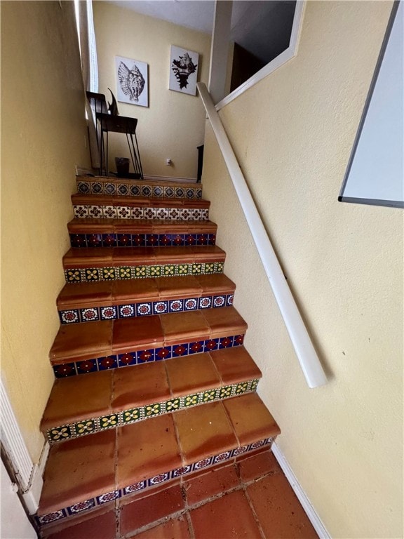 stairway with tile patterned flooring