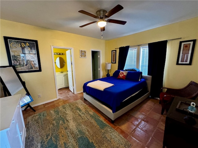 tiled bedroom featuring ceiling fan and ensuite bathroom