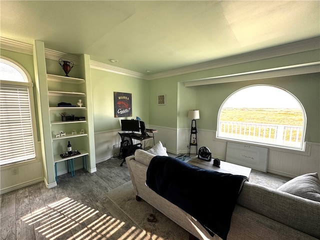 living room with hardwood / wood-style floors, a wealth of natural light, and ornamental molding