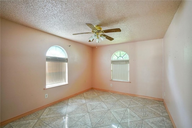 unfurnished bedroom with a textured ceiling, ceiling fan, and a closet