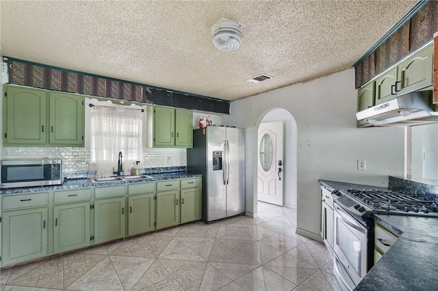 kitchen featuring stainless steel appliances, green cabinets, and sink