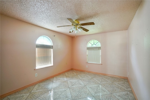 spare room with a textured ceiling and ceiling fan