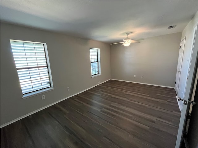 spare room featuring ceiling fan and dark hardwood / wood-style flooring