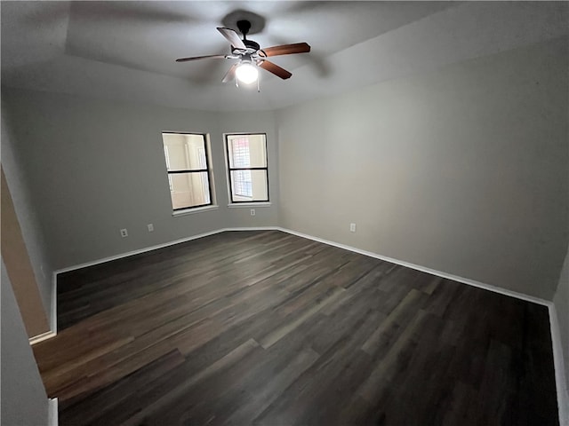 unfurnished room featuring ceiling fan and dark hardwood / wood-style flooring