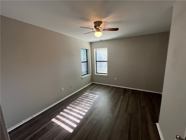 empty room featuring dark hardwood / wood-style floors and ceiling fan