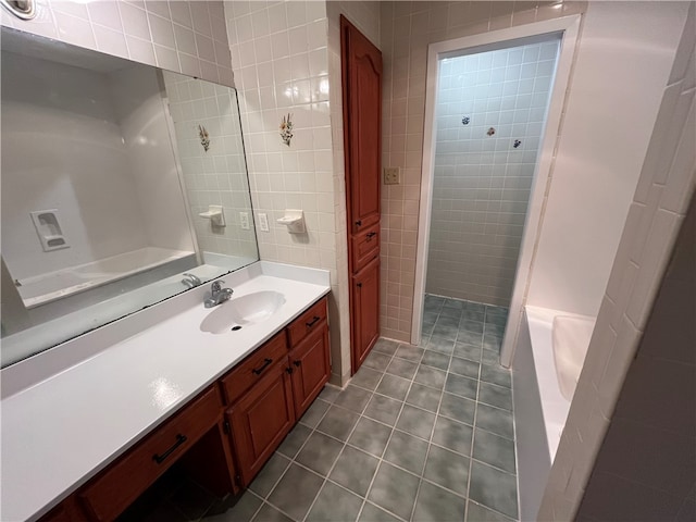 bathroom with vanity and tile walls